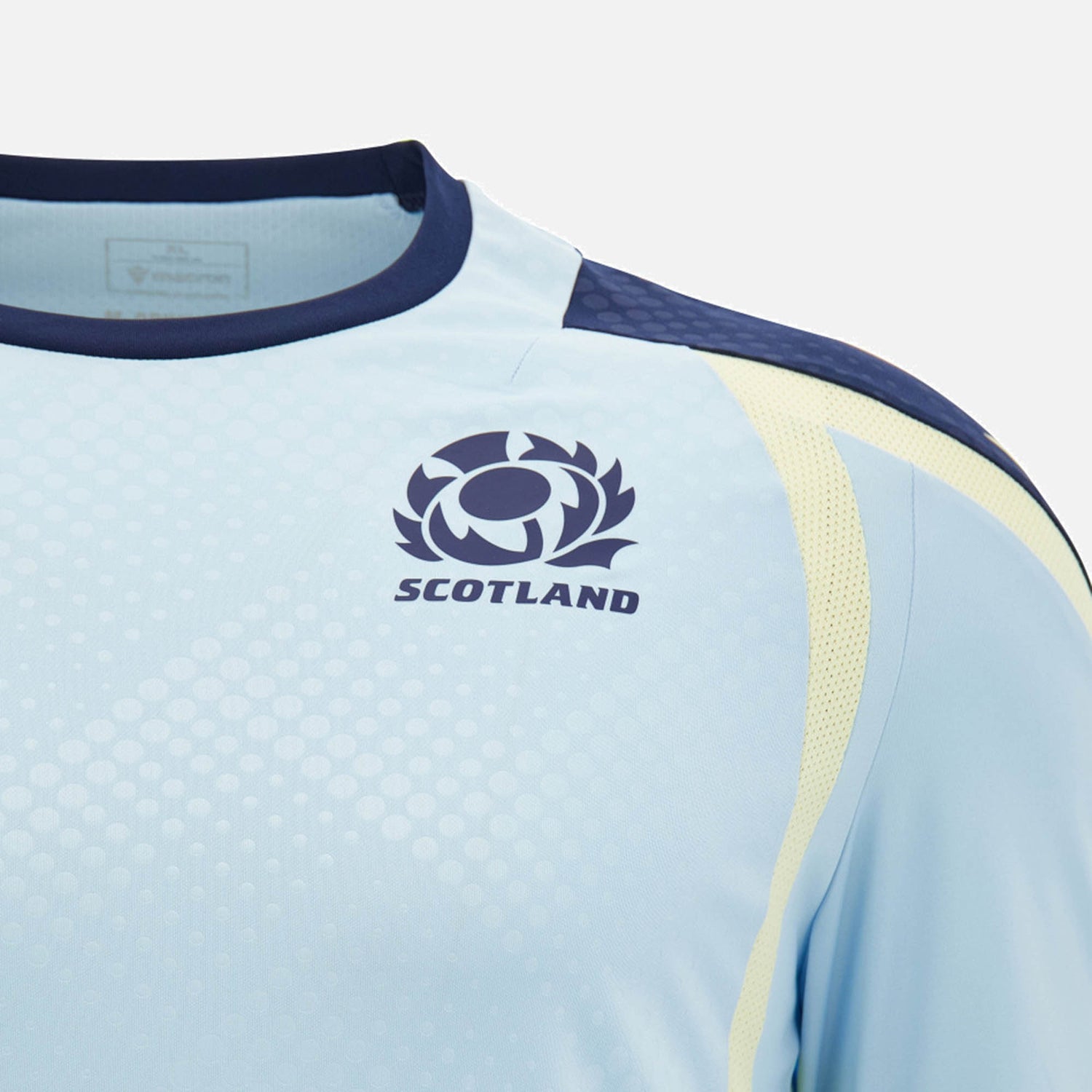 Close-up of the Scotland SRU 26/27 Player Training Shirt by Macron in light blue, showcasing the Scotland rugby logo and dark blue trim on the collar and shoulder.
