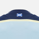Back of the Scotland SRU 26/27 Player Training Shirt by Macron, featuring a small Scottish flag on the collar. The light blue jersey, made by Macron, showcases classic navy and yellow accents on a plain background—reflecting the iconic style of an official Scotland Rugby training shirt.