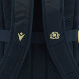Close-up of the navy shoulder straps with mesh padding on the Scotland SRU 26/27 Backpack by Macron, featuring two yellow logos—one chevron-shaped and one circular with a stylized thistle—that highlight its distinctive design.