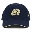 The Scotland SRU 26/27 Thistle Baseball Cap by Macron features a navy blue design with a cream embroidered thistle logo on the front and a cream stripe on the brim.