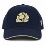 The Scotland SRU 26/27 Thistle Baseball Cap by Macron features a navy blue design with a cream embroidered thistle logo on the front and a cream stripe on the brim.