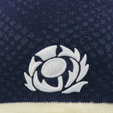 Close-up of the Scotland SRU 26/27 Knit Beanie by Macron in navy blue, featuring the white Scottish Rugby Union logo embroidered on the fabric, highlighting the quality craftsmanship of this Macron beanie.