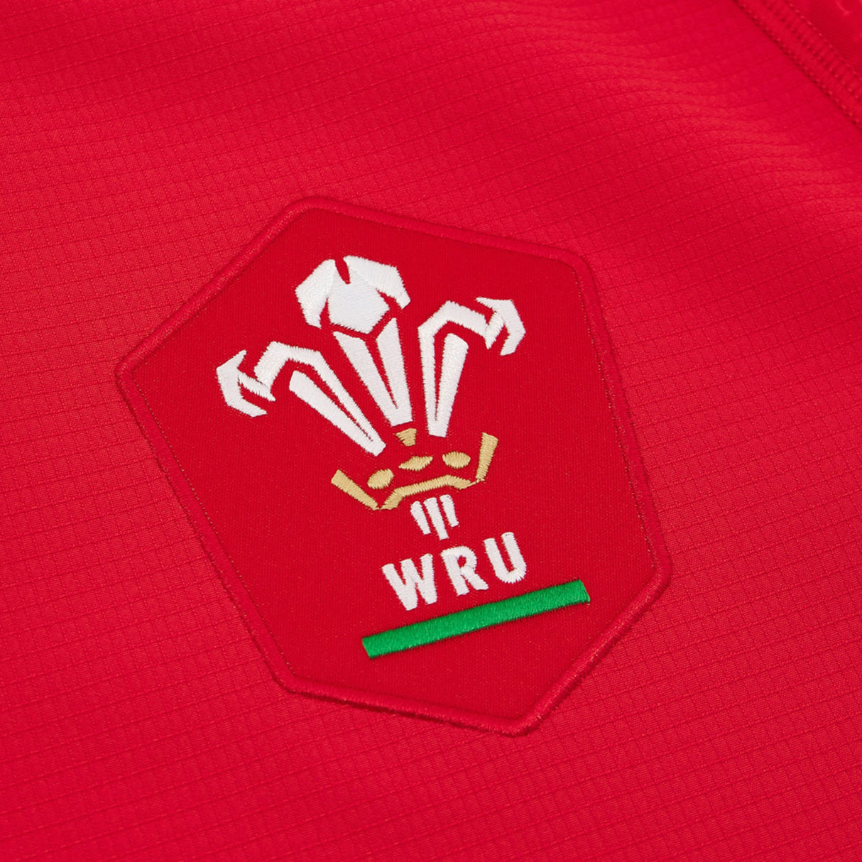 Close-up of the Welsh Rugby Union (WRU) logo embroidered on the Wales WRU 26/27 Authentic Matchday Home Jersey by Macron.