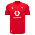 The Wales WRU 26/27 Replica Home Jersey by Macron is a red short-sleeve rugby shirt featuring the white Vodafone logo, WRU crest, and Macron branding on the front. Part of the official Macron 26/27 collection, this replica jersey is perfect for supporters looking to show their pride.