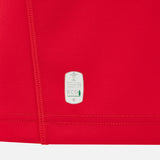 Close-up of the red fabric from the Wales WRU 26/27 Replica Home Jersey by Macron, highlighting a white label that reads “Official Product ECO” with a small tree graphic—signifying the use of eco-friendly materials in this Macron rugby shirt.