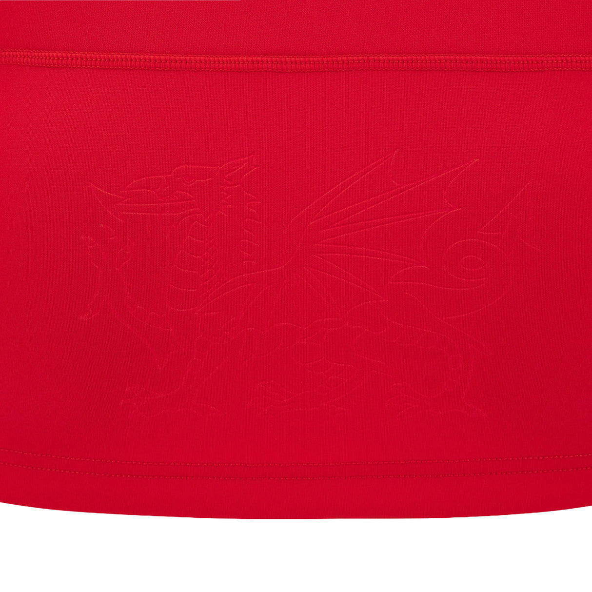 A striking red fabric featuring an embossed dragon with outstretched wings and a curled tail at its center, echoing the bold design of the Wales WRU 26/27 Replica Home Jersey by Macron.