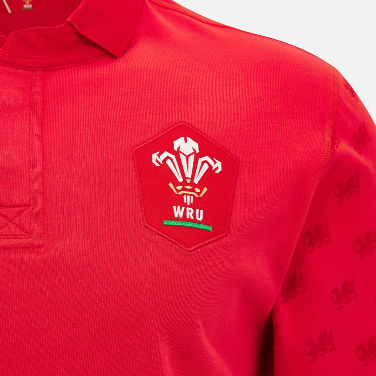 Close-up of the Wales WRU 26/27 Classic Long Sleeve Home Jersey by Macron in vibrant red, showcasing the Welsh Rugby Union (WRU) logo on the chest and detailed dragon patterns along the sleeves.
