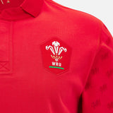 Close-up of the Wales WRU 26/27 Classic Long Sleeve Home Jersey by Macron in vibrant red, showcasing the Welsh Rugby Union (WRU) logo on the chest and detailed dragon patterns along the sleeves.