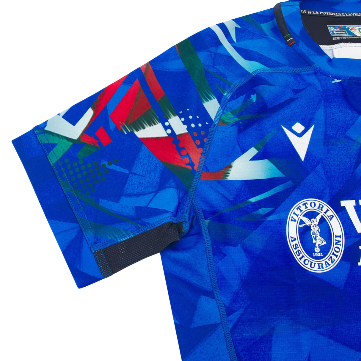 The Italy 26/27 Home Authentic Jersey by Macron showcases a geometric blue design with a white crest, the “Vittoria Assicurazioni” logo, and vibrant shoulder accents. Expertly crafted for the Italy Rugby Jersey collection, this official jersey blends stylish flair with sporting tradition.