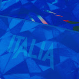 Close-up of an Authentic blue fabric with geometric patterns and the bold, translucent “ITALIA” lettering—a signature detail from the Italy 26/27 Home Authentic Jersey by Macron.