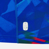 Close-up of the Italy 26/27 Home Replica Jersey by Macron, featuring blue geometric patterns, visible stitching, and an “Official Licensed Product” eco-friendly label near the seam. This jersey from Macron exemplifies quality craftsmanship and attention to detail.
