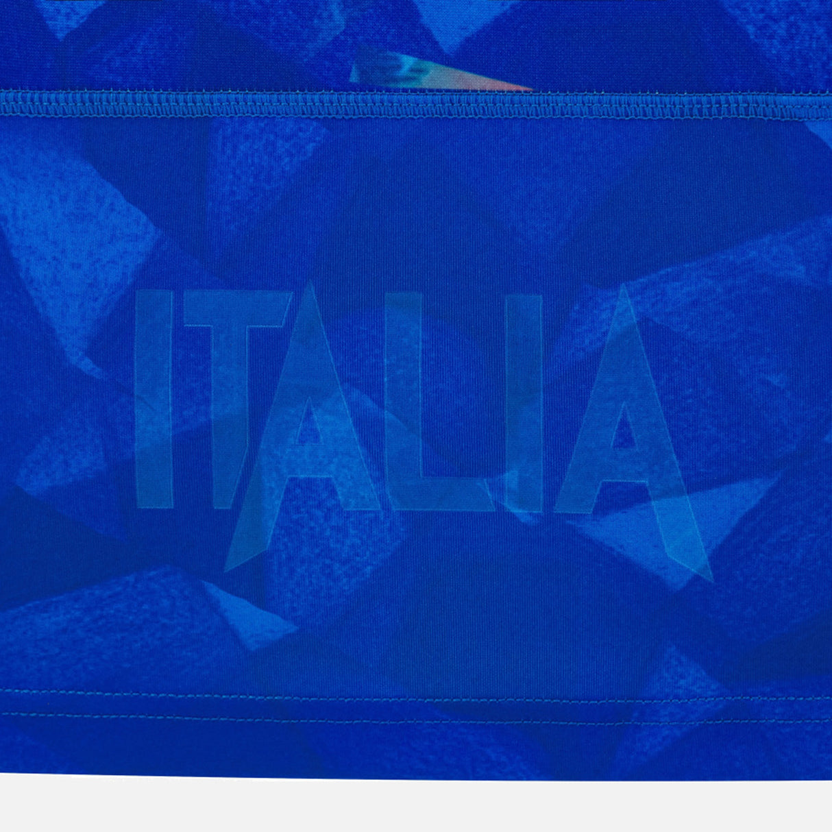 Crafted by Macron, the Italy 26/27 Home Replica Jersey features blue fabric adorned with geometric patterns and the word “ITALIA” boldly displayed in large, semi-transparent letters across the center—a vibrant celebration of Italian pride and rugby heritage.