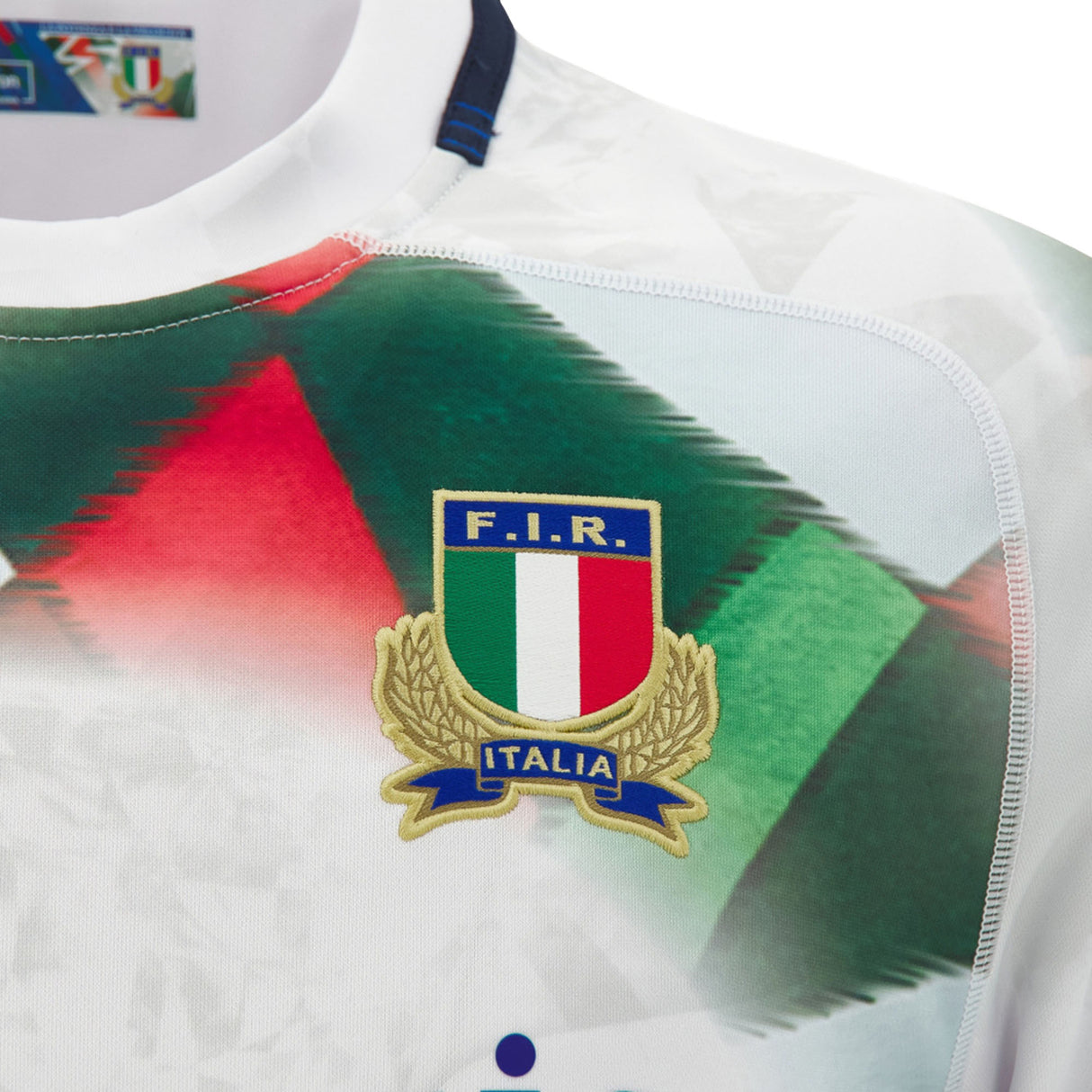 Close-up of the Italy 26/27 Away Replica Jersey by Macron, showcasing the F.I.R. crest with a gold laurel and a design featuring red, green, and white accents.