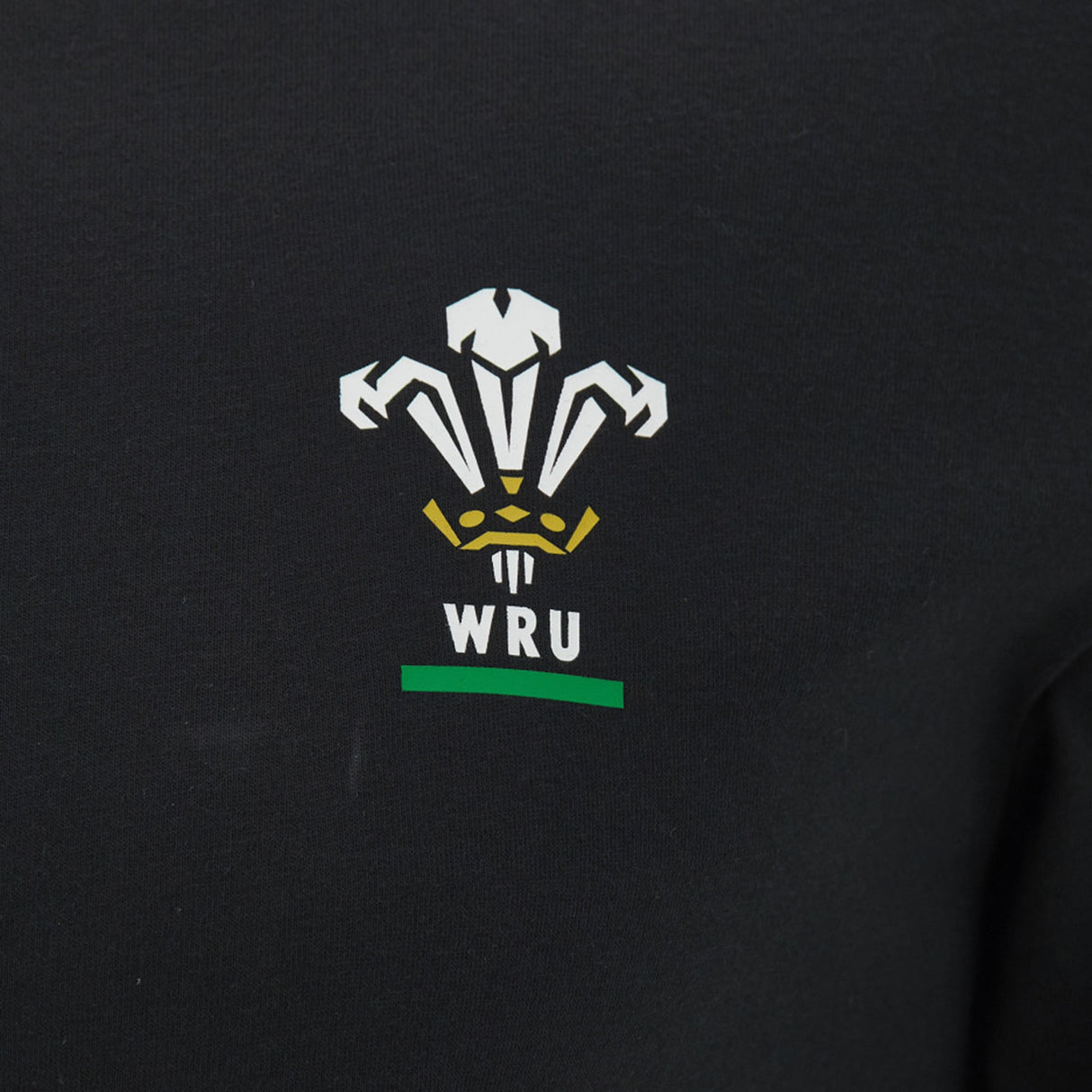 The Wales WRU 26/27 Goalpost Fan Cotton T-Shirt by Macron features black fabric adorned with the Welsh Rugby Union (WRU) logo in white, gold, and green—including three stylized feathers above the “WRU” lettering—making it a perfect choice for fans wanting a classic Welsh Rugby look.
