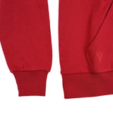 Close-up of the sleeves and waistband of the Wales WRU 26/27 Fan Cotton Hoodie by Macron in bold red, featuring a small textured logo on the right side—perfect for fans seeking that authentic Macron style.