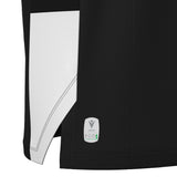 Close-up of the hem of the black and white Wales WRU 26/27 Travel Basketball Singlet by Macron, showing a Macron ECO logo tag with a tree graphic on the lower edge.
