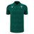 Wales WRU 26/27 Travel Poly Polo by Macron in green, featuring black shoulder accents, white chest logos, and a subtle checkered pattern.