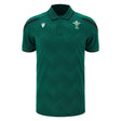 Wales WRU 26/27 Travel Poly Polo by Macron in green, featuring black shoulder accents, white chest logos, and a subtle checkered pattern.