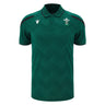 Wales WRU 26/27 Travel Poly Polo by Macron in green, featuring black shoulder accents, white chest logos, and a subtle checkered pattern.