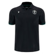 Introducing the Wales WRU 26/27 Travel Cotton Polo by Macron—a black short-sleeve polo shirt crafted from comfortable cotton, designed with a classic collar. It features a white embroidered crest on the left chest and a subtle white Macron logo on the right chest. Inspired by classic Macron rugby shirt styling, this polo embodies timeless team spirit and enduring comfort.