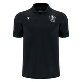 Introducing the Wales WRU 26/27 Travel Cotton Polo by Macron—a black short-sleeve polo shirt crafted from comfortable cotton, designed with a classic collar. It features a white embroidered crest on the left chest and a subtle white Macron logo on the right chest. Inspired by classic Macron rugby shirt styling, this polo embodies timeless team spirit and enduring comfort.