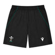 The Wales WRU 26/27 Travel Training Shorts by Macron feature a black design with an elastic waistband, green accents, a white WRU logo on the left leg, and a white Macron logo on the right leg. Displayed on a plain background, these athletic shorts offer a comfortable fit ideal for workouts or casual wear.