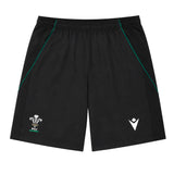 The Wales WRU 26/27 Travel Training Shorts by Macron feature a black design with an elastic waistband, green accents, a white WRU logo on the left leg, and a white Macron logo on the right leg. Displayed on a plain background, these athletic shorts offer a comfortable fit ideal for workouts or casual wear.