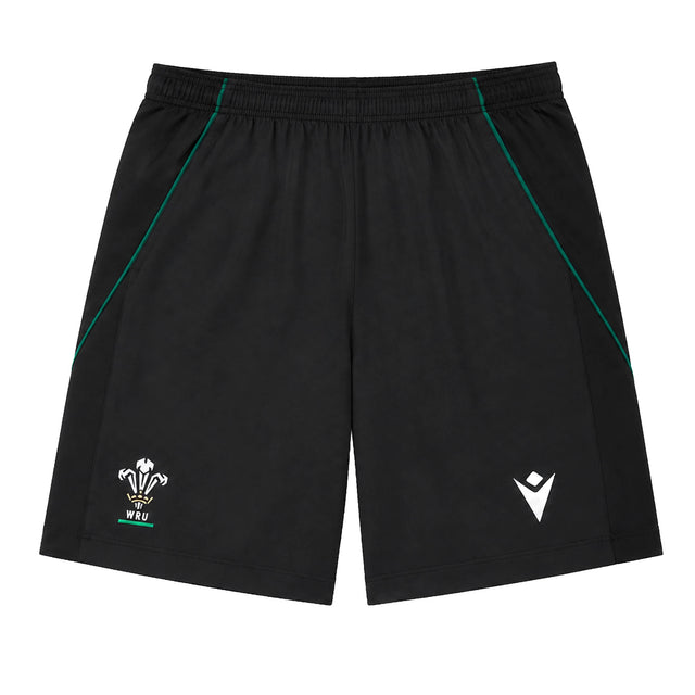 The Wales WRU 26/27 Travel Training Shorts by Macron feature a black design with an elastic waistband, green accents, a white WRU logo on the left leg, and a white Macron logo on the right leg. Displayed on a plain background, these athletic shorts offer a comfortable fit ideal for workouts or casual wear.