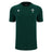 The Wales WRU 26/27 Travel Poly/Cotton T-Shirt by Macron is a plain dark green short-sleeve shirt featuring a white Macron logo on the right chest and the Welsh Rugby Union (WRU) emblem on the left chest, from the WRU travel collection.