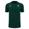 The Wales WRU 26/27 Travel Poly/Cotton T-Shirt by Macron is a plain dark green short-sleeve shirt featuring a white Macron logo on the right chest and the Welsh Rugby Union (WRU) emblem on the left chest, from the WRU travel collection.