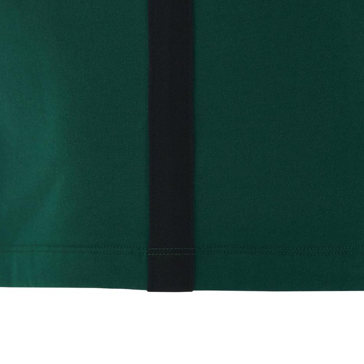 Close-up of a green fabric from the Wales WRU 26/27 Travel Poly/Cotton T-Shirt by Macron, showcasing a vertical black stripe and visible stitching along the bottom edge—a standout item from the Macron travel collection.