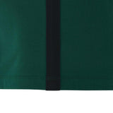 Close-up of a green fabric from the Wales WRU 26/27 Travel Poly/Cotton T-Shirt by Macron, showcasing a vertical black stripe and visible stitching along the bottom edge—a standout item from the Macron travel collection.
