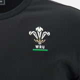 Discover the Wales WRU 26/27 Travel Poly/Cotton T-Shirt by Macron, shown here in black as part of the official WRU travel collection. This stylish t-shirt features the Welsh Rugby Union (WRU) logo expertly embroidered in white, gold, and green on the chest, complemented by iconic Macron branding for an added touch of quality craftsmanship.