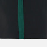 Close-up of a black fabric featuring a single vertical green stripe down the center, inspired by the sleek design elements of the Wales WRU 26/27 Travel Poly/Cotton T-Shirt by Macron.