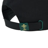 Close-up of the back of the Wales WRU 26/27 Baseball Cap by Macron, highlighting an adjustable strap with a green clasp adorned with a yellow WRU logo.