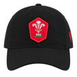 The Wales WRU 26/27 Dad Cap by Macron is a black cap featuring a red patch with the Welsh Rugby Union (WRU) logo—three feathers and “WRU” text—on the front. This stylish Macron cap is perfect for any supporter wanting to show their passion for Welsh rugby.
