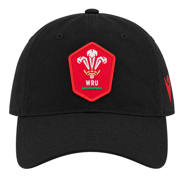 The Wales WRU 26/27 Dad Cap by Macron is a black cap featuring a red patch with the Welsh Rugby Union (WRU) logo—three feathers and “WRU” text—on the front. This stylish Macron cap is perfect for any supporter wanting to show their passion for Welsh rugby.