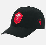 The Wales WRU 26/27 Dad Cap by Macron features a black design with a bold red Welsh Rugby Union (WRU) crest on the front and a red Macron logo on the side, shown against a plain background—ideal for fans seeking an authentic touch of Welsh rugby style.