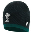 The Wales WRU 26/27 Knit Beanie by Macron features a black and green knit design with the iconic Welsh Rugby Union logo and a white Macron brand logo on the front.
