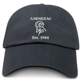 The Amoskeag Rugby Club Adult Low-Profile Cotton Twill Dad Cap by EMB S&S Activewear features "AMOSKEAG," a stylized ram's head, and "Est. 1984" embroidered in white on the black cotton twill front.