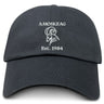The Amoskeag Rugby Club Adult Low-Profile Cotton Twill Dad Cap by EMB S&S Activewear features "AMOSKEAG," a stylized ram's head, and "Est. 1984" embroidered in white on the black cotton twill front.