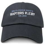 The EMB S&S Activewear South Orange County Raptors Adult Low-Profile Cotton Twill Dad Cap is a black dad cap with white embroidered text on the front that reads “South Orange County Raptors Rugby Est. 2005.”.