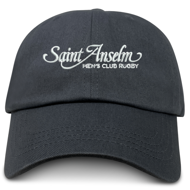 The EMB S&S Activewear Saint Anselm College Club Rugby Adult Low-Profile Cotton Twill Dad Cap is black with white “Saint Anselm Men’s Club Rugby” embroidered on the front.
