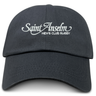 The EMB S&S Activewear Saint Anselm College Club Rugby Adult Low-Profile Cotton Twill Dad Cap is black with white “Saint Anselm Men’s Club Rugby” embroidered on the front.