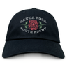 The EMB S&S Activewear Santa Rosa Youth Rugby Adult Low-Profile Cotton Twill Dad Cap features black cotton twill construction, a red rose, and “Santa Rosa Youth Rugby” embroidered team branding on the front.