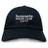 The Hornets Rugby Club 1977 Adult Low-Profile Cotton Twill Dad Cap by EMB S&S Activewear features black cotton twill and white embroidered "hornets RUGBY CLUB 1977" team branding on the front.