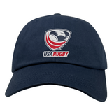 Presenting the USA Rugby Dad Cap by EMB Alpha Broder: a navy blue cap displaying the USA Rugby logo with a bold eagle design in red, white, and blue. Ideal for rugby fans eager to back their team with flair.