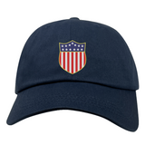 The USA Rugby Original Olympic Dad Cap by EMB S&S Activewear features a shield with stars and red-white stripes—a stylish accessory for rugby fans.