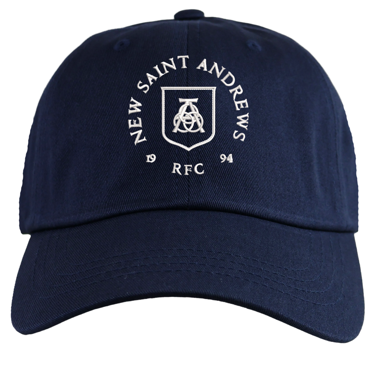 Introducing the New Saint Andrews College Adult Low-Profile Cotton Twill Dad Cap by EMB S&S Activewear: a navy blue hat featuring “New Saint Andrews RFC 1994” and a white embroidered crest on the front, combining classic team style with a timeless dad cap design.