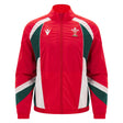 The Wales WRU 26/27 Heritage Retro Jacket by Macron is a red zip-up jacket with green and white accents, featuring the Welsh Rugby Union logo on the left chest and the Macron logo on the right, showcasing classic heritage rugby style from Macron.